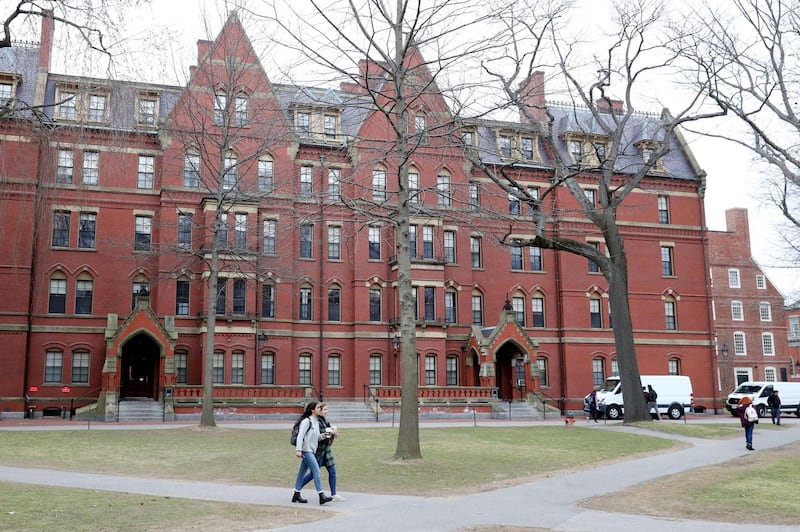 CAMBRIDGE, MASSACHUSETTS - MARCH 12: Students walk through Harvard Yard on the campus of Harvard University on March 12, 2020 in Cambridge, Massachusetts. Students have been asked to move out of their dorms by March 15 due to the Coronavirus (COVID-19) risk. All classes will be moved online for the rest of the spring semester.   Maddie Meyer/Getty Images/AFP
== FOR NEWSPAPERS, INTERNET, TELCOS & TELEVISION USE ONLY ==
