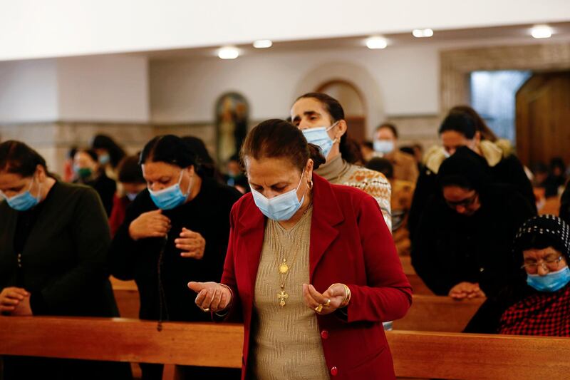 Iraqi Christians attend a mass in a church in Qaraqosh, Iraq, Monday, Feb. 22, 2021. Iraq's Christians are hoping that a historic visit by Pope Francis in March will help boost their community's struggle to survive. AP Photo