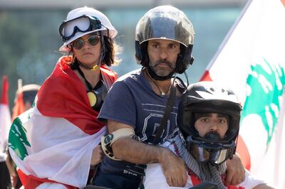 epa08007982 Lebanese protesters leave with a motorbike in a blocked road leading to the Parliament, in Beirut, Lebanon, 19 November 2019. The session to elect committee members was postponed indefinitely amid mounting pressure from protesters in Beirut as they closed all roads leading to the parliament building in Beirut on the 34th day of nationwide anti-government protests. Protests continue in Lebanon since 17 October, as protesters aim to apply pressure on the country's political leaders over what they view as a lack of progress following the prime minister's resignation on 29 October.  EPA/ANDRE PAIN  EPA-EFE/ANDRE PAIN