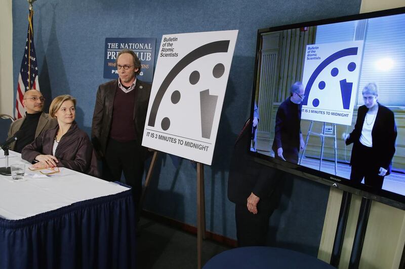 Sivan Kartham, left, senior scientist at the Stockholm Environment Institute in Massachusetts, Sharon Squassoni, director of the Centre for Strategic and International Studies’ proliferation prevention programme, and Lawrence Krauss, director of Arizona State University’s New Origins Initiative, unveil the Doomsday Clock with other scientists at the National Press Club in Washington, DC on January 26, 2016. Chip Somodevilla / Getty Images / AFP