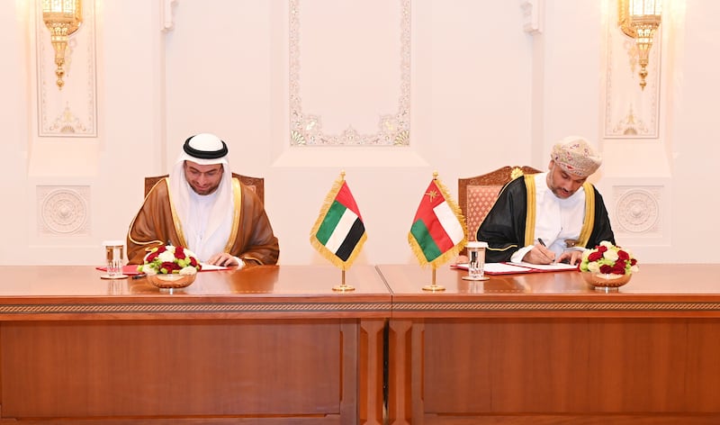 Shadi Malak, chief executive of Etihad Rail, and Abdulrahman Salim Al Hatmi, chief executive of Oman's state-owned logistics company Asyad, sign the co-operation deal to link the UAE and Oman by rail. Photo: Oman News Agency
