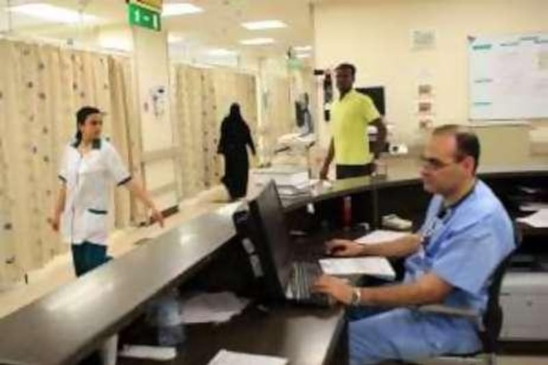 28July 2010 - Abu Dhabi - Doctor works a case sheet in Emergency ward at Al Mafraq hospital in Abu Dhabi. Ravindranath K / The National
