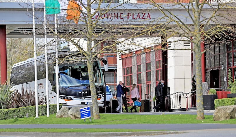 Airline passengers in Dublin leave the bus to enter the Crowne Plaza hotel to begin their period of quarantine. Image: Getty Images