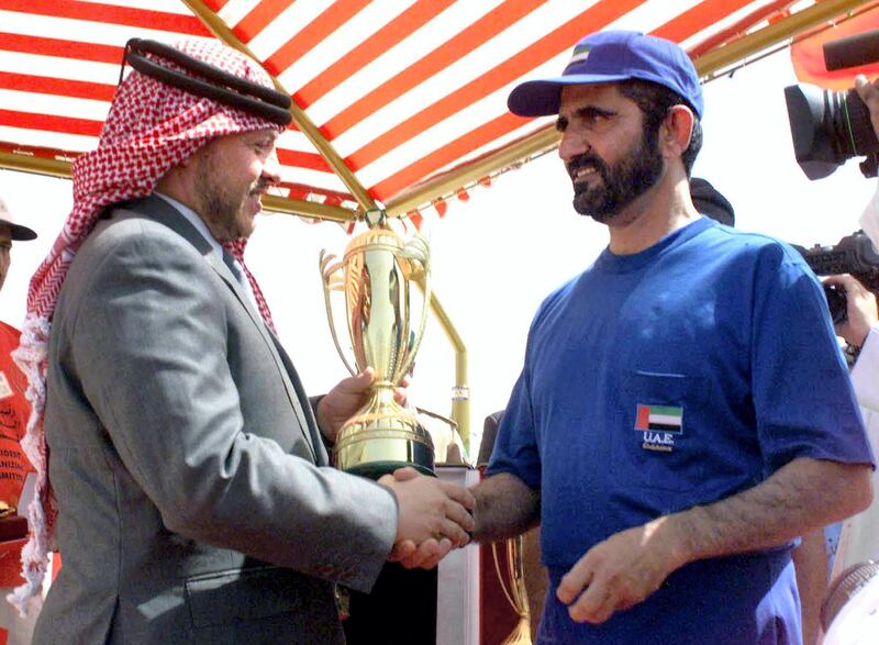 Dubai Crown Prince and UAE Defence Minister Sheikh Mohammed bin Rashid al-Maktum (R), winner of the first Bahrain Endurance Ride, an equestrian marathon, receives a trophy 07 April 2000 from King Abdullah II of Jordan in Manama. (Photo by AFP)