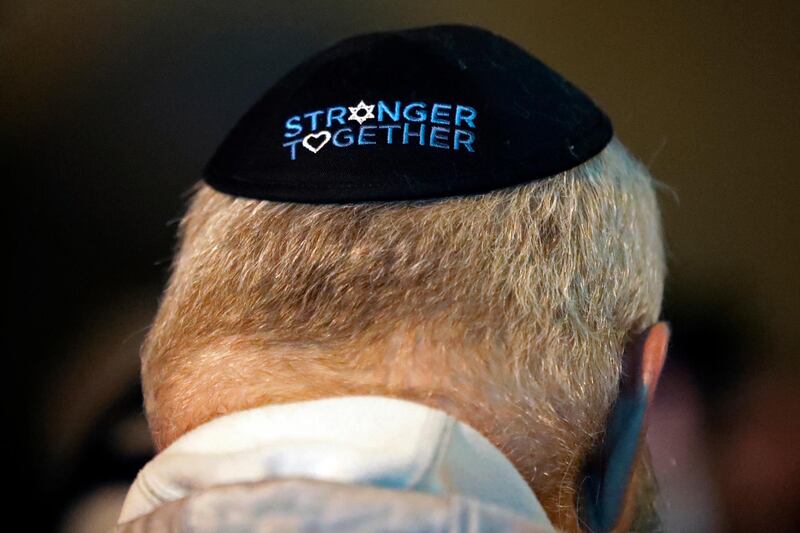 A man takes part in a vigil outside the Tree of Life Synagogue in the Squirrel Hill neighborhood of Pittsburgh to honor the victims of the attack, Saturday April 27, 2019. It was six months to the day that a gunman shot and killed 11 people while they worshipped at the Tree of Life Synagogue on Oct. 27, 2018. AP Photo