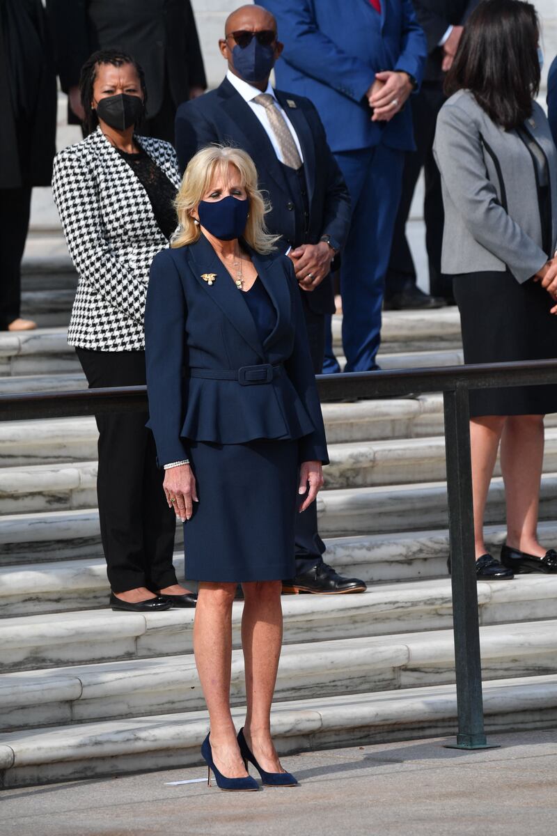 Jill Biden, in a belted navy dress and jacket, attends a Veterans Day event in Arlington, Virginia on November 11, 2021. AFP