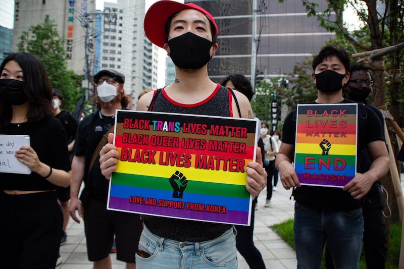 People hold banners during a Black Lives Matter rally in central Seoul, South Korea.  EPA