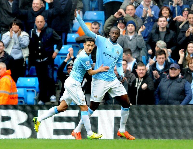 Manchester City midfielder Yaya Toure, right, celebrates with teammate Jesus Navas after scoring from the penalty spot against Southampton on Saturday. Rui Vieira / AP / April 5, 2014