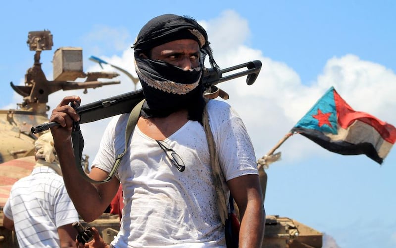 A supporter of Yemen's Southern Separatist Movement stands in front of a tank flying the movement's flag near the international airport in the port city of Aden. Southerners may want to leave the union, but, says Faisal Al Yafai, may soon come to regret it. (AFP PHOTO / SALEH AL-OBEIDI)





