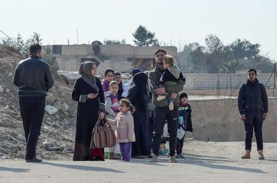 Syrian families flee their homes in the Ghwayran neighbourhood of Hassakeh, near the jail where ISIS freed a number of insurgent prisoners. AFP