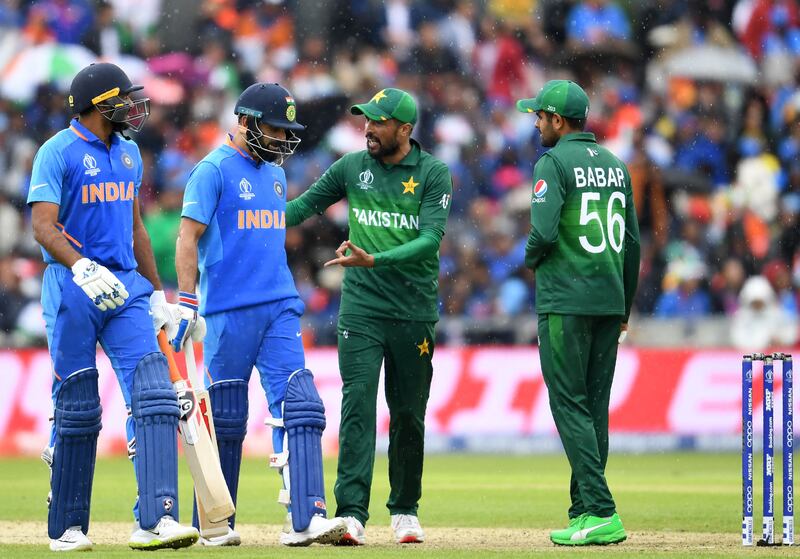 Pakistan and India players walk back to the pavilion during a rain delay in their 2019 World Cup match in Manchester. AFP