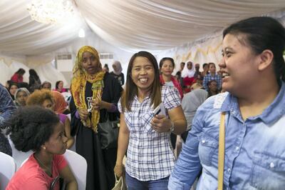 ABU DHABI, UNITED ARAB EMIRATES - AUGUST 5, 2018. 

“All people don’t know we are sad. A smile is hiding all.” says  Maulida “Ina”, center, 30, from Indonesia. Ina is seeking amnesty today at Al Shahama immigration centre in Abu Dhabi.

Thousands of undocumented workers streamed into the center today as they sought to take advantage of the government's new amnesty law. 
 
(Photo by Reem Mohammed/The National)

Reporter: Anna Zacharias
Section:  NA