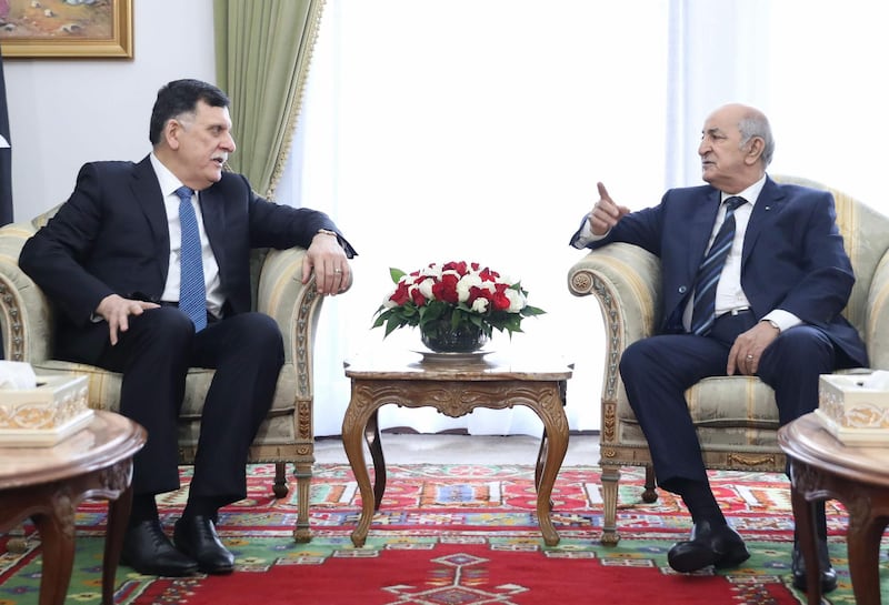 Algeria's President Abdelaziz Tebboune (R) meets with Libya's UN-recognised Prime Minister Fayez al-Sarraj upon his arrival in Algiers on January 6, 2020 for talks on the Libyan crisis. The head of Libya's UN-recognised government and Turkey's foreign minister were scheduled to visit Algeria amid mounting regional tensions over Libya. Since a 2011 NATO-backed uprising that killed longstanding dictator Moamer Kadhafi, Libya has been plunged into chaos. It is now divided between the GNA and rival authorities based in the country's east, each with regional backers. - 
 / AFP / -
