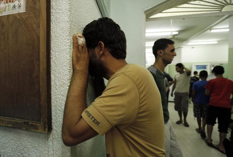 A Palestinian man cries following the assault. Mohammed Abed / AFP Photo 