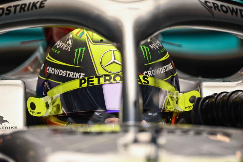 Mercedes' British driver Lewis Hamilton sits in his car in the pits. AFP