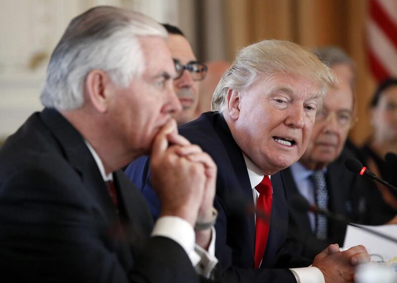 The US President Donald Trump and his secretary of state, Rex Tillerson, left, both said the US missile strikes on a Syrian airbase on April 7, 2017 were strictly a warning to the Assad regime against using chemical weapons. Alex Brandon / AP Photo / April 7, 2017