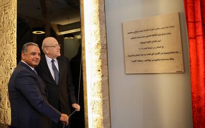 Lebanon's Prime Minister Najib Mikati, right, and Culture Minister Mohammad Mortada unveil a commemorative plaque during the reopening ceremony of the National Library in Beirut on February 10. AFP