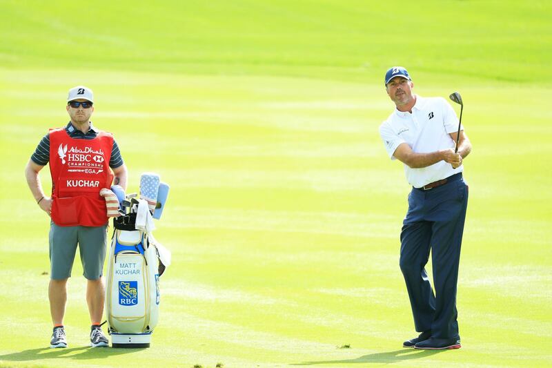 Matt Kuchar of the United States plays a shot on the 11th hole as his caddie Lance Bennett  looks on during the pro-am. Andrew Redington/Getty Images