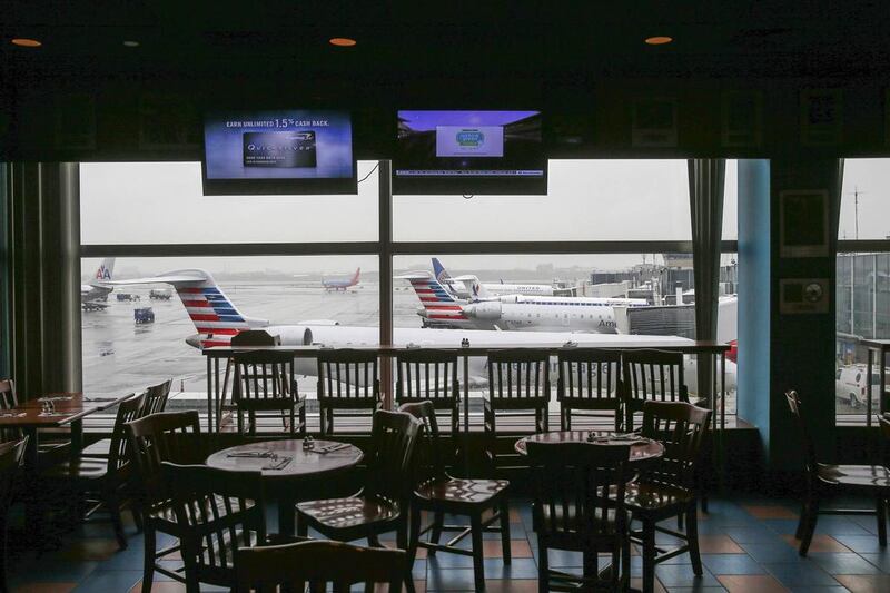 Empty chairs are seen at a restaurant in the central terminal of LaGuardia Airport in the Queens borough of New York. Shannon Stapleton / Reuters