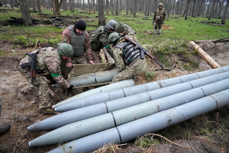 Ukrainian soldiers collect multiple Russian 'Uragan' missiles after recent battles in the village of Berezivka, Ukraine. AP