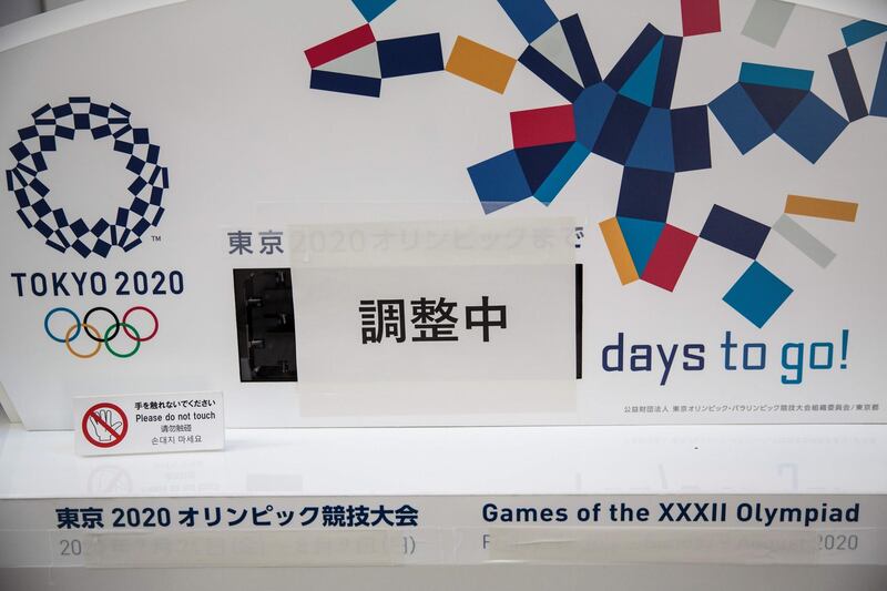 A notice reads in Japanese "Under adjustment" is pasted on a countdown display for the Tokyo 2020 Olympics in Tokyo on March 25. AFP