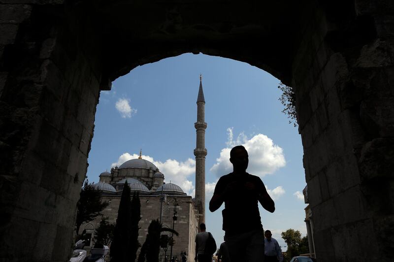 A man walks near Fatih mosque in Istanbul. Syrians say Turkey has been detaining and forcing some Syrian refugees to return back to their country the past month. The expulsions reflect increasing anti-refugee sentiment in Turkey, which opened its doors to millions of Syrians fleeing their country's civil war. AP Photo