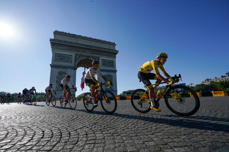 Tadej Pogacar, wearing the overall leader's yellow jersey, passes the Arc de Triomphe during the 21st andfinal stage of the Tour de France, on Sunday, July 18.