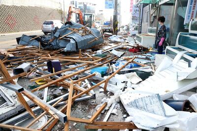 A woman looks at debris caused by Typhoon Maysak in Pohang, South Korea, September 3, 2020.    Yonhap via REUTERS   ATTENTION EDITORS - THIS IMAGE HAS BEEN SUPPLIED BY A THIRD PARTY. SOUTH KOREA OUT. NO RESALES. NO ARCHIVE.