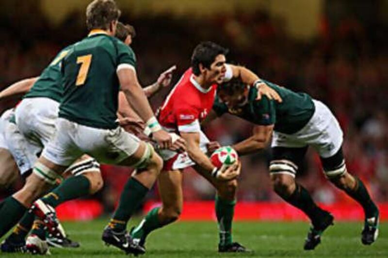 James Hook of Wales is tackled by Ryan Kankowski of South Africa during the match at the Millennium Stadium in Cardiff.