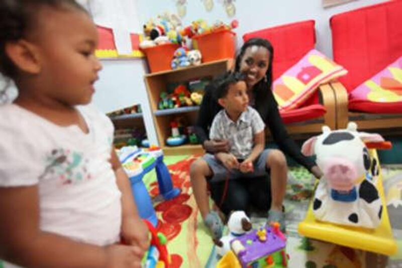 United Arab Emirates - Abu Dhabi - June 7, 2010.



PERSONAL FINANCE: Nimo Abdi (cq-al), 35, plays with her children Zain Harvey (cq-al), 3, center in her lap, and Nawal Harvey (cq-al), 2, left, at the Bright Beginnings Nursery in Abu Dhabi on Monday, June 7, 2010. "Where we live, we're very lucky. We have the park, the pool and other free facilities," said Abdi, who works at the British Embassy on how she and her family save. "The beach is a fantastic place to go to for free." Amy Leang/The National