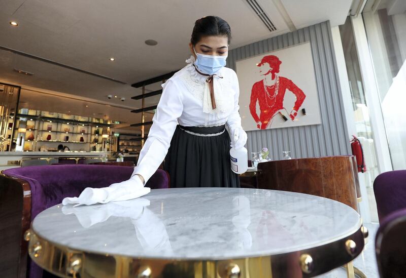 Dubai, United Arab Emirates - Reporter: N/A. News. Coronavirus/Covid-19. An employee at disinfects a table before welcoming customers in Dubai. Wednesday, November 11th, 2020. Dubai. Chris Whiteoak / The National