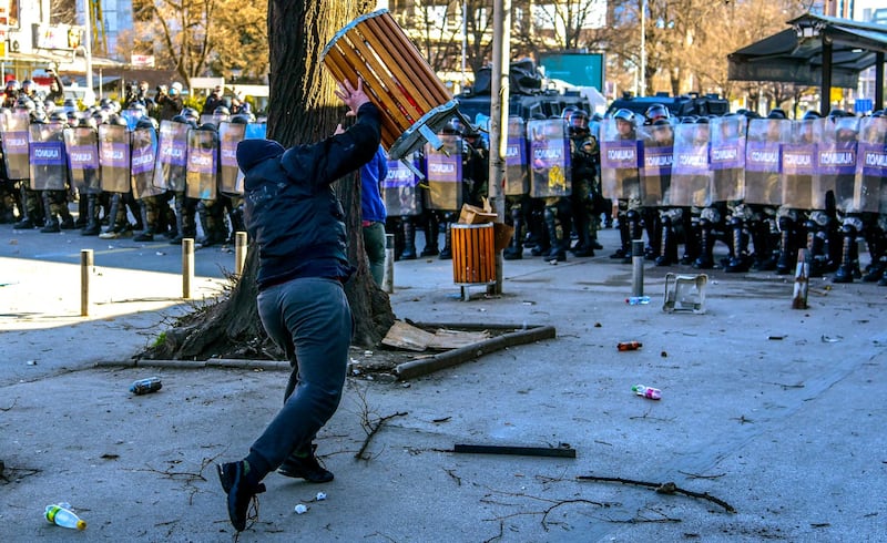 An ethnic Albanian protester throws a bin at riot police in Skopje, North Macedonia. The protests followed the sentencing of a group of ethnic Albanians for the murder of five ethnic Macedonians. Supporters claim those convicted have been scapegoated. EPA