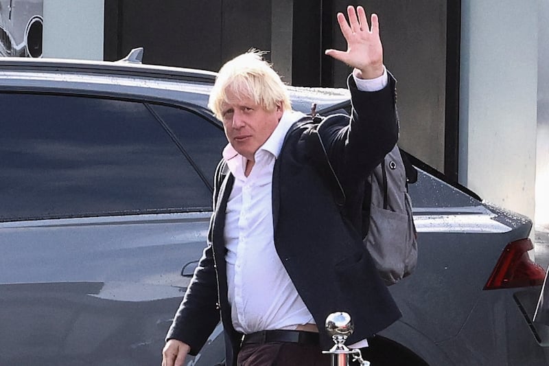 Former British prime minister Boris Johnson waves at Gatwick Airport, near London, on Saturday. Reuters