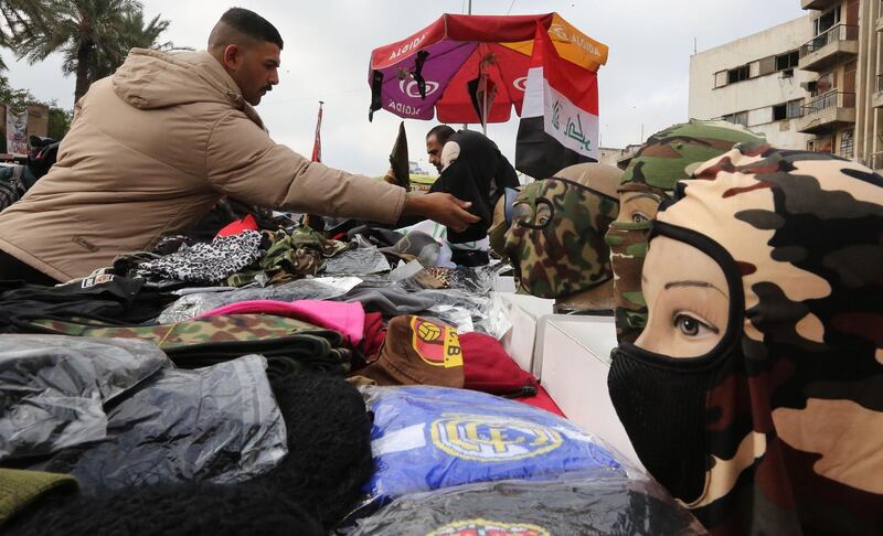 An Iraqi street vendor sells masks, popular among protesters who prefer to cover their faces during anti-government demonstrations, in Tahrir Square in Iraq's capital Baghdad.  AFP