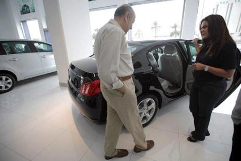 Car dealers are offering low interest rates, free insurance and extended warranties to boost sales. Sammy Dallal / The National