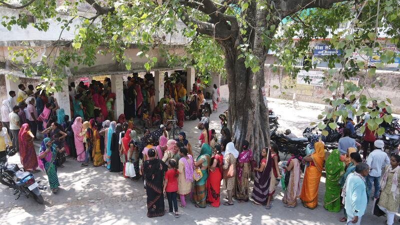 People queue to register outside the district hospital in Ballia