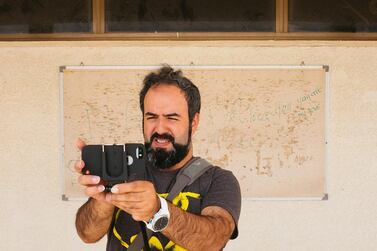 Hassan Kiyany filming his documentary 'Zaabil iDoc' in 2014. Courtesy Ammar Al Attar