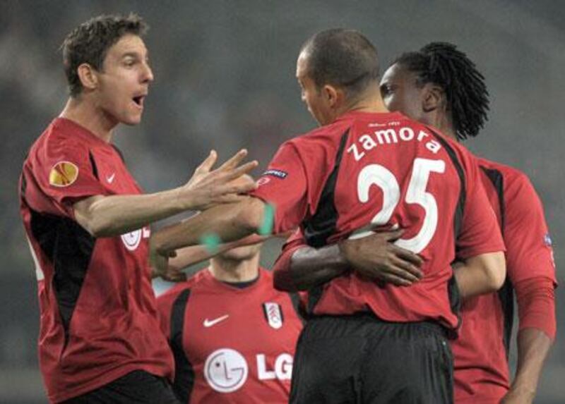 FC Fulham's Zoltan Gera, left, celebrates with teammate Bobby Zamora, centre, after scoring against VfL Wolfsburg during their Europa League quarterfinals game in Wolfsburg, Germany, on Thursday, April 8, 2010.