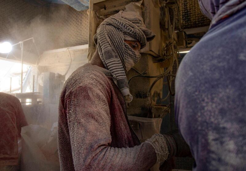 A worker fills bags with corn at the southern Iraqi port of Umm Qasr near Basra. AFP