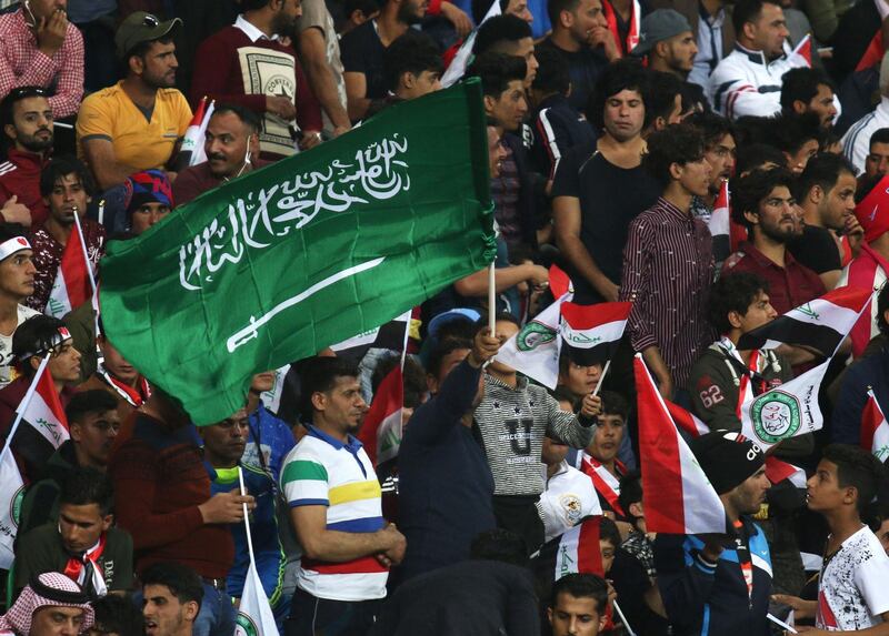 A football fan waves a Saudi Arabian flag during the friendly football match between Iraq and Saudi Arabia at the Basra Sports city stadium in Basra on February 28, 2018. 
Iraq has not played full internationals on home turf ever since its 1990 invasion of Kuwait that sparked an international embargo. Iraq won the match 4-1 / AFP PHOTO / HAIDAR MOHAMMED ALI