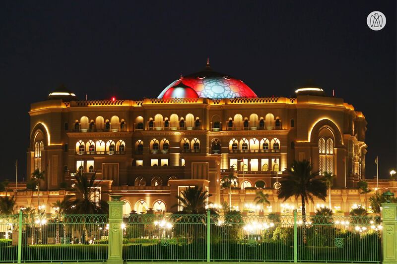 The dome of the Emirates Palace hotel in Abu Dhabi is lit in the colours of the Singapore flag.