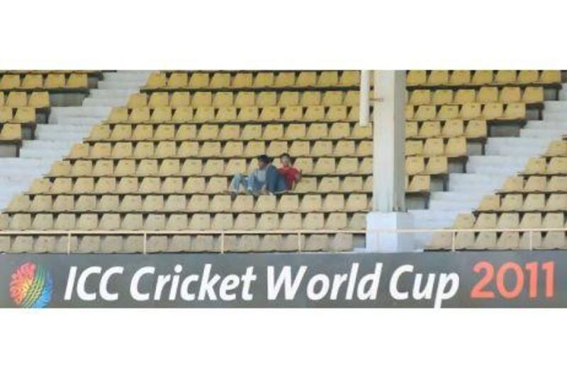 Two fans attempt to fill the stands in the Australia-Zimbabwe game at the 55,000-capacity Sardar Patel Gujarat Stadium in Ahmedabad on Monday.