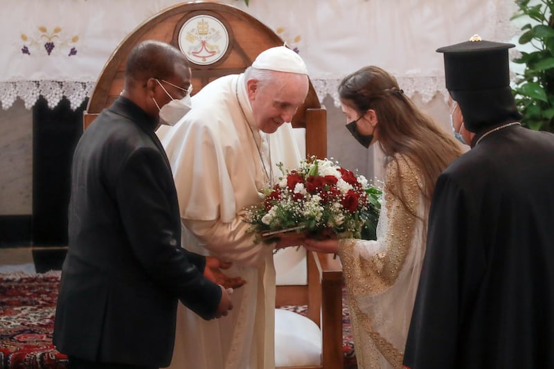 Pope Francis is welcomed upon his arrival at the Our Lady of Salvation Church. AP Photo