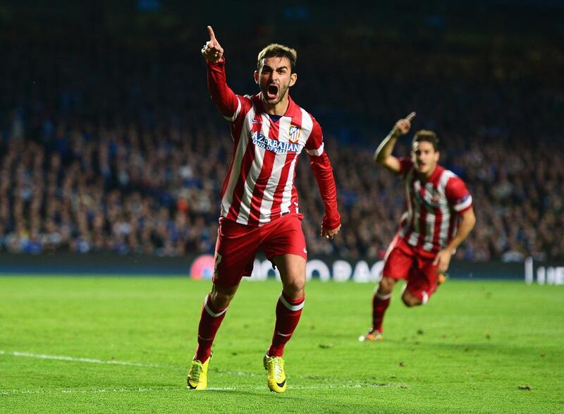 Adrian Lopez of Atletico Madrid celebrates his goal in the Champions League semi-final against Chelsea on Wednesday. Jamie McDonald / Getty Images / April 30, 2014