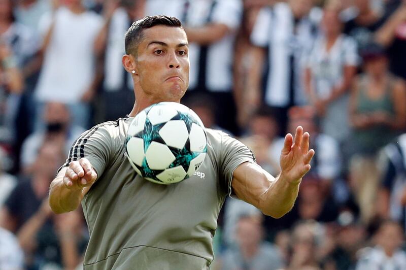 FILE -- In this Sunday, Aug.12, 2018 file photo Cristiano Ronaldo controls the ball during a friendly match between the Juventus A and B teams, in Villar Perosa, northern Italy. Ronaldo just moved from Real Madrid to Juventus in a Serie A record 112 million-euro ($131.5 million) deal which the Italian media labeled "the swoop of the century." (AP Photo/Antonio Calanni)