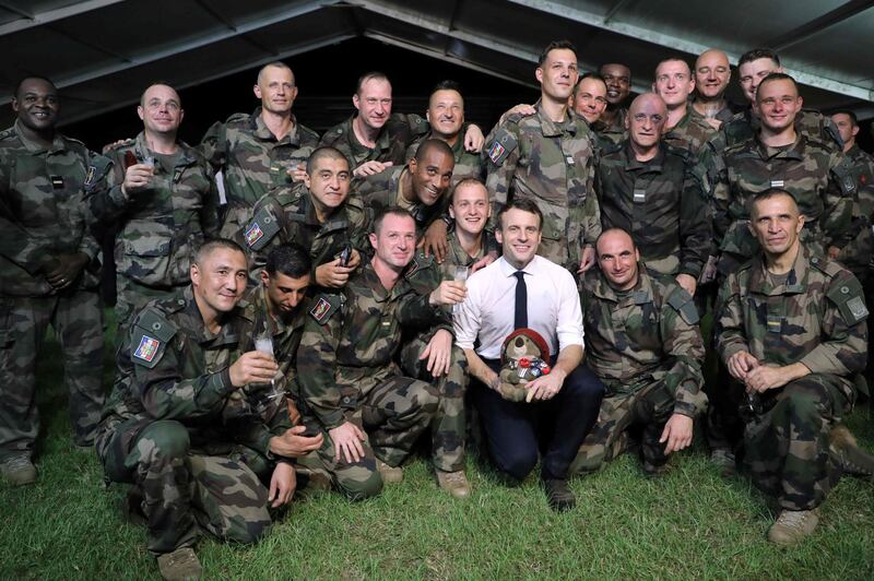 French President Emmanuel Macron celebrates his 42nd birthday with French soldiers.  AFP