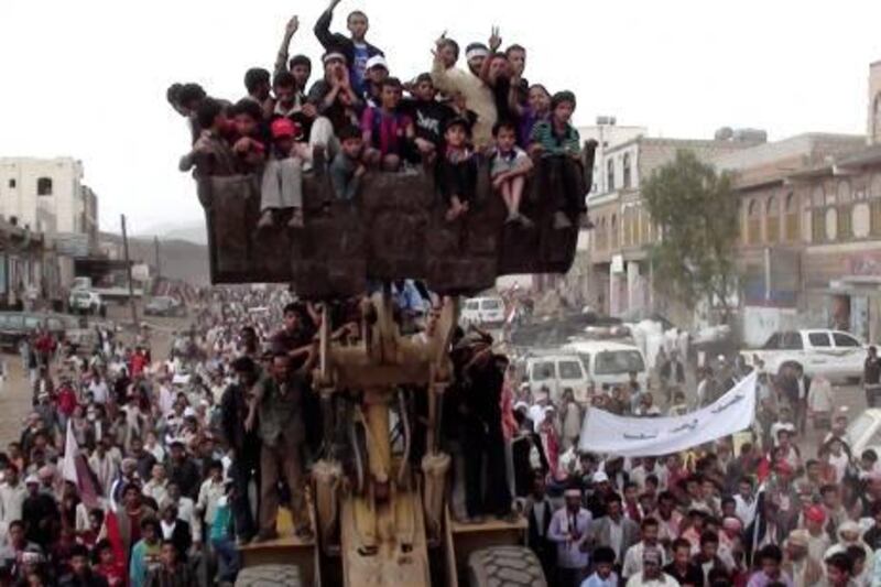 Anti-government protesters are carried by a bulldozer during a demonstration to demand the ouster of Yemen's President Ali Abdullah Saleh in Damt town of the southern Dhalea province May 20, 2011. Saleh called on Friday for early elections in an apparent bid to stave off Gulf and Western pressure to leave office, as thousands rallied for and against his three-decade rule. REUTERS/Stringer (YEMEN - Tags: POLITICS CIVIL UNREST ODDLY) *** Local Caption ***  SAN13_YEMEN-_0520_11.JPG
