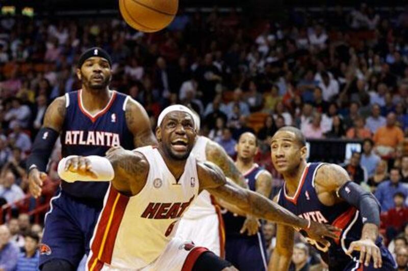 Lebron James is defended by Utah's Jamaal Tinsley and Randy Foye.