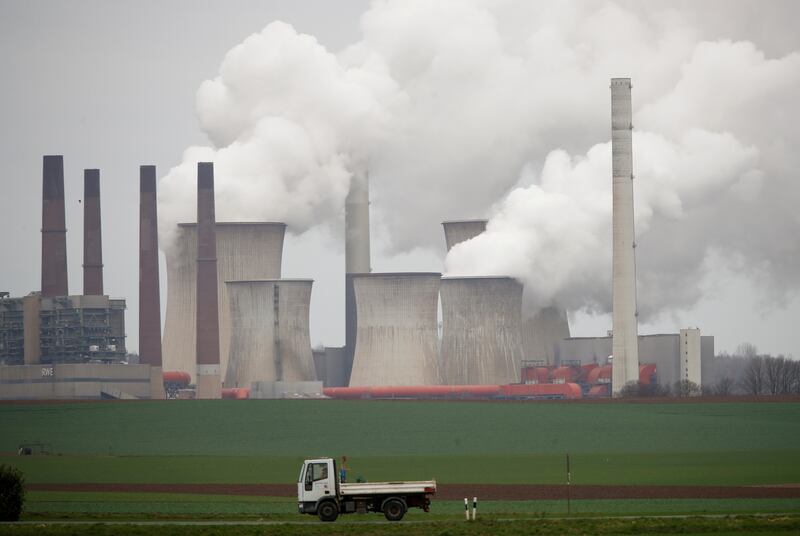 A truck drives by as steam rises from the five brown coal-fired power units of RWE, one of Europe's biggest electricity companies in Neurath, north-west of Cologne, Germany. REUTERS