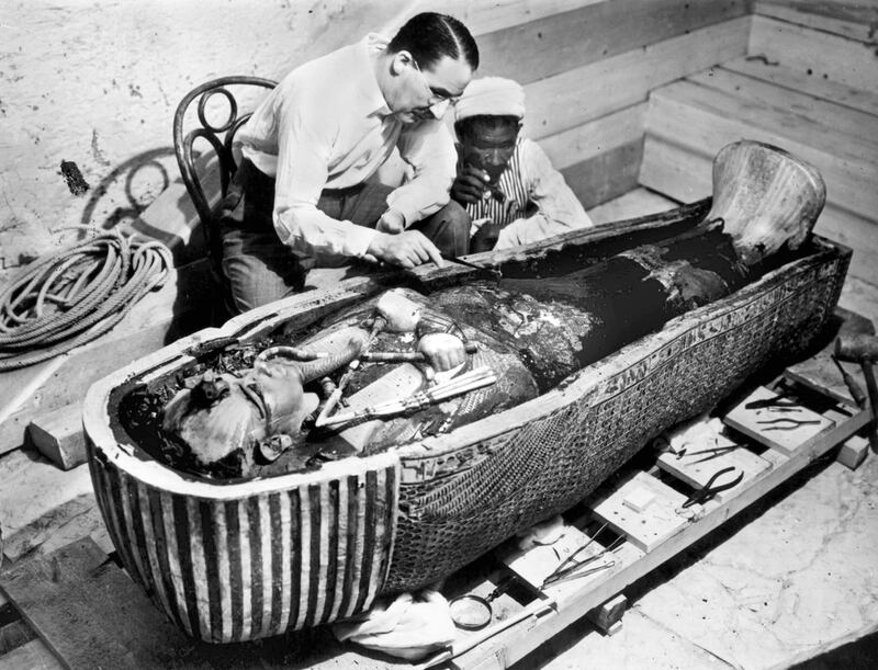 Howard Carter examines the golden sarcophagus of Tutankhamun in Egypt in 1922. All photos: Getty Images